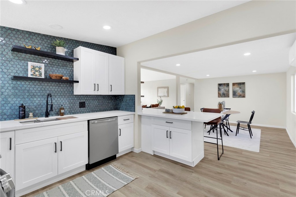 14344 Central Road Apple Valley, CA 92307 - Photo 16 of 61 a large white kitchen with stainless steel appliances granite countertop a sink and cabinets