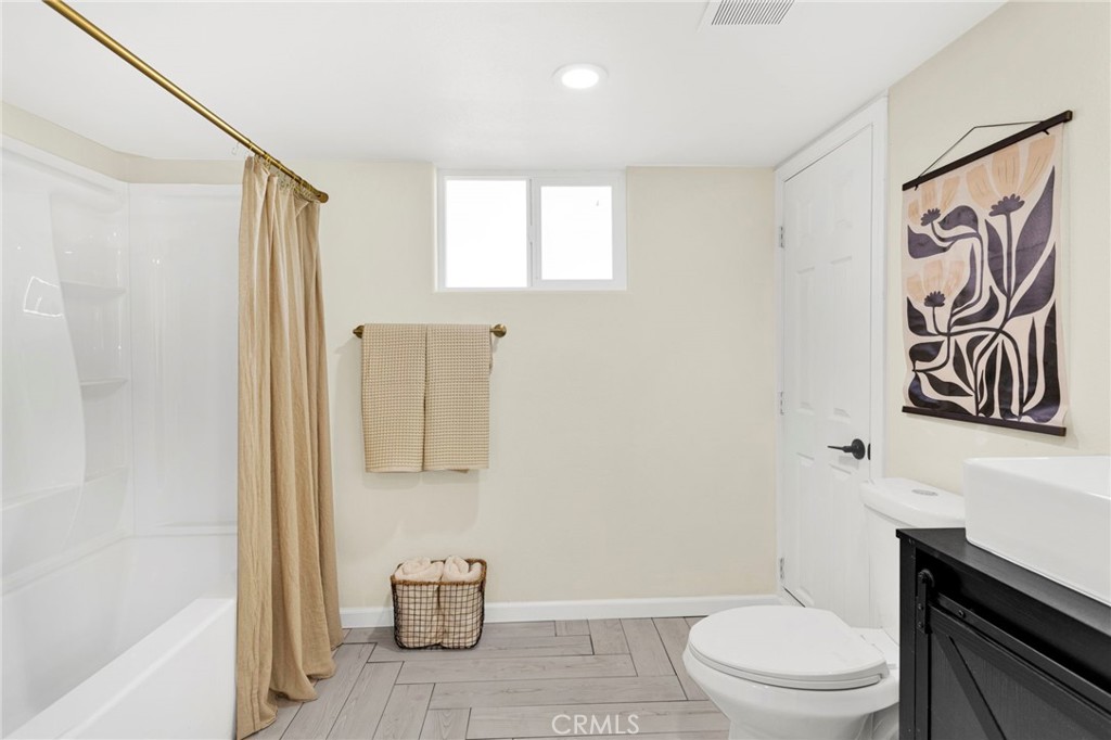 14344 Central Road Apple Valley, CA 92307 - Photo 22 of 61 a bathroom with a toilet and a shower