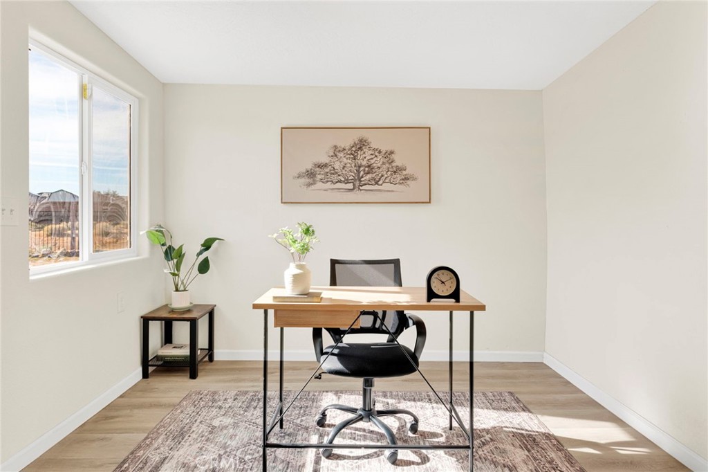 14344 Central Road Apple Valley, CA 92307 - Photo 25 of 61 a view of a workspace with furniture and a potted plant
