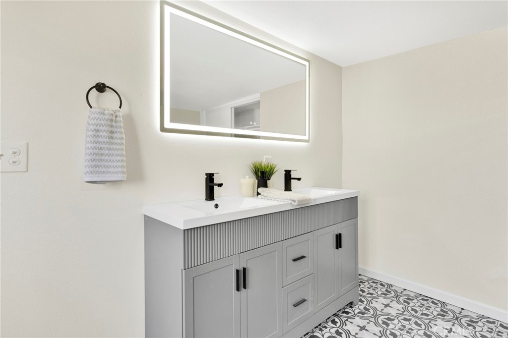 14344 Central Road Apple Valley, CA 92307 - Photo 31 of 61 a bathroom with a sink and a mirror