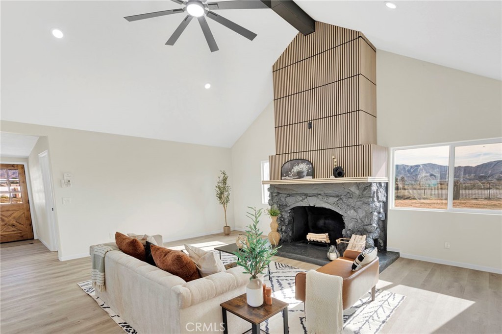 14344 Central Road Apple Valley, CA 92307 - Photo 4 of 61 a living room with furniture and a fireplace
