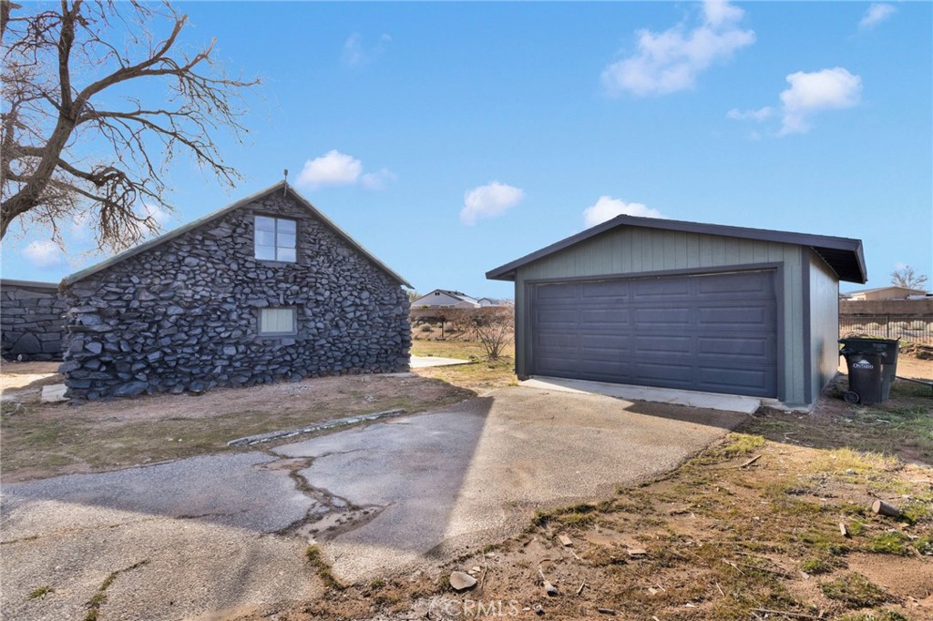 14344 Central Road Apple Valley, CA 92307 - Photo 42 of 61 a front view of a house with a yard and garage
