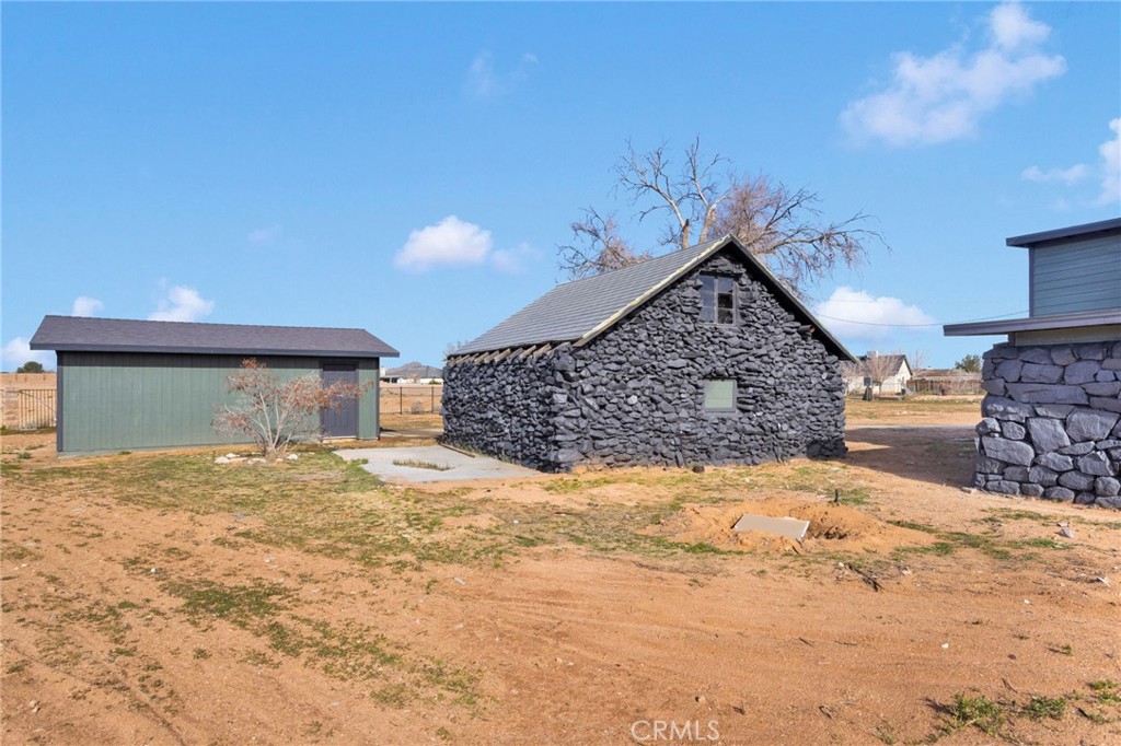 14344 Central Road Apple Valley, CA 92307 - Photo 45 of 61 a view of yellow house with a yard