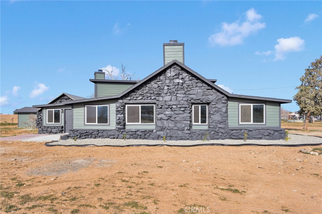 14344 Central Road Apple Valley, CA 92307 - Photo 48 of 61 a front view of a house with a yard