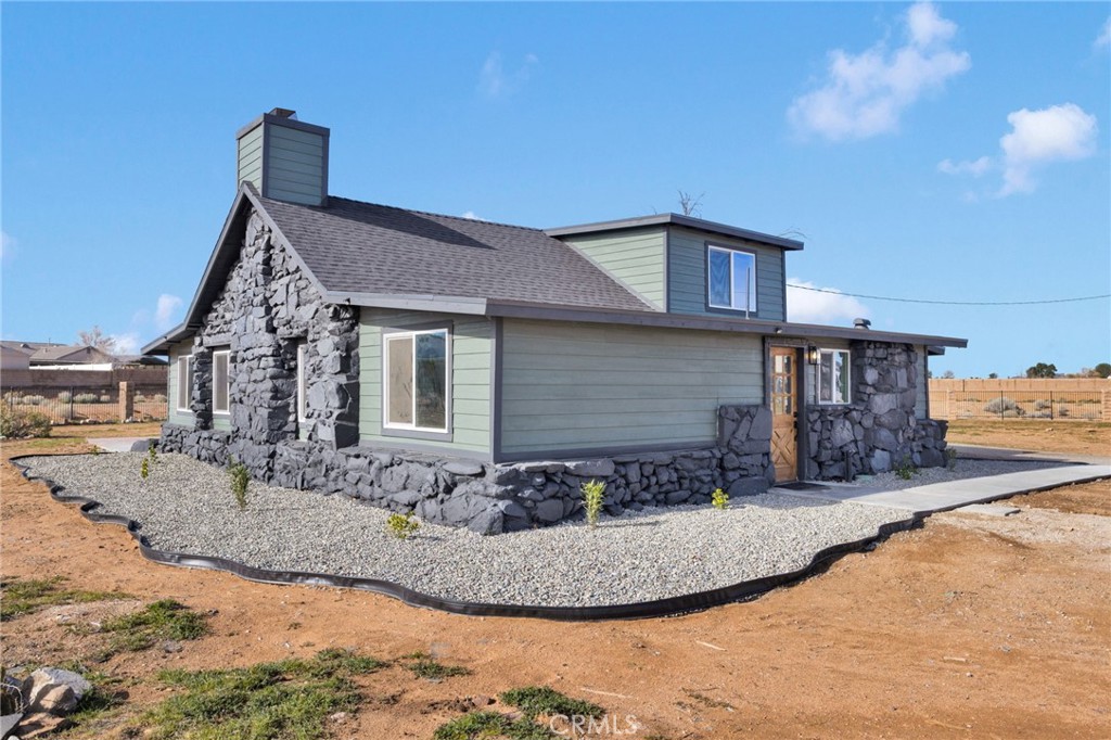 14344 Central Road Apple Valley, CA 92307 - Photo 49 of 61 a view of a house with a snow in the background