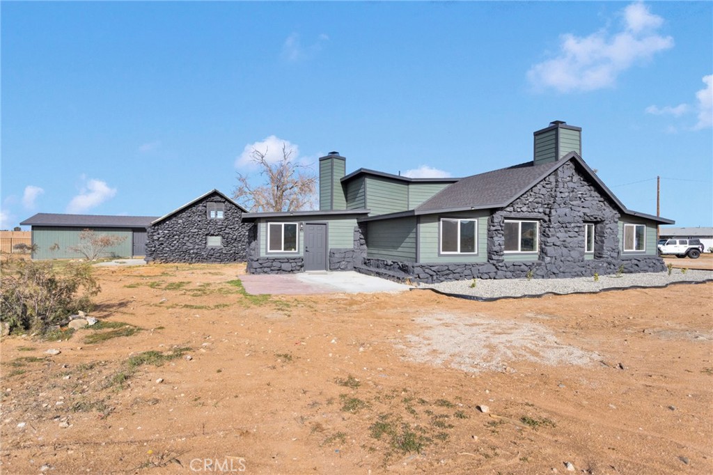14344 Central Road Apple Valley, CA 92307 - Photo 50 of 61 a front view of a house with a yard covered in snow