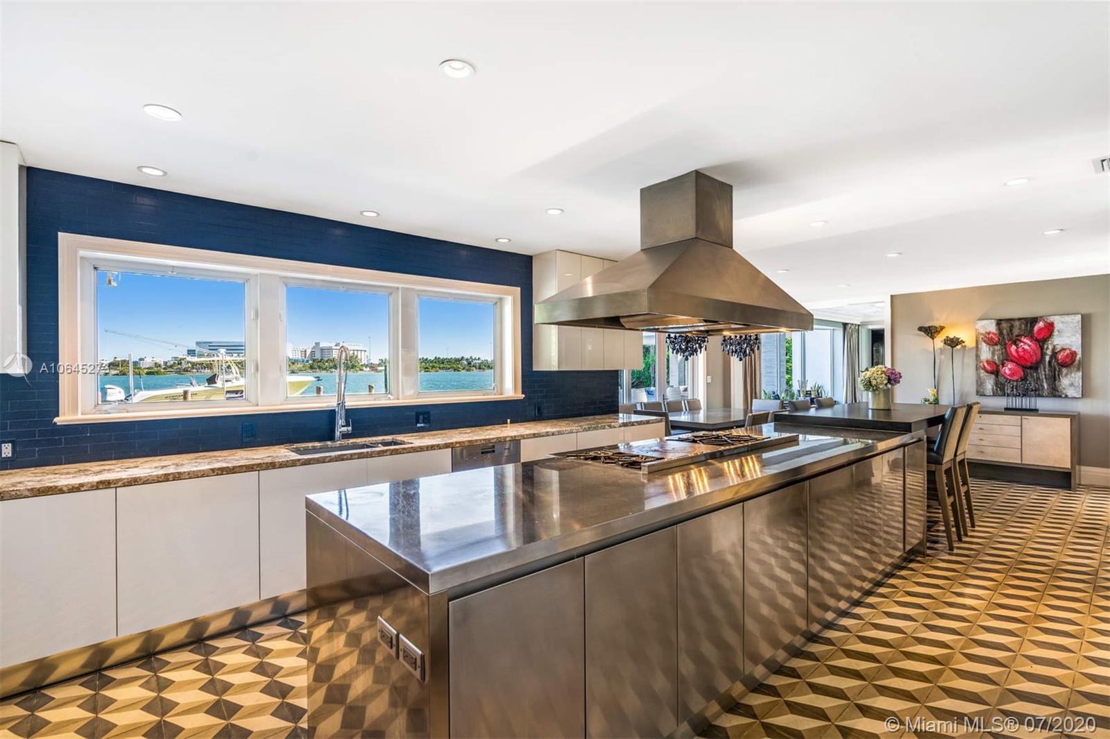 1475 North View Drive Miami Beach, FL 33140 - Photo 15 of 27 a kitchen with stainless steel appliances granite countertop a sink and a stove