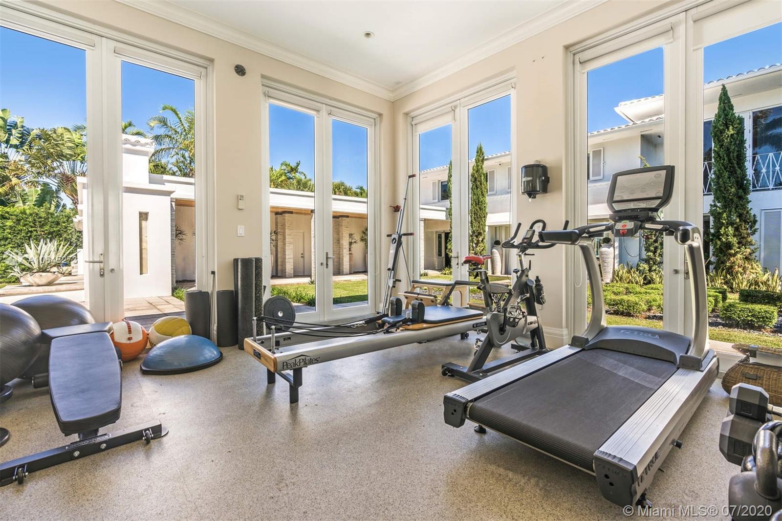 1475 North View Drive Miami Beach, FL 33140 - Photo 25 of 27 a room with gym equipment and windows