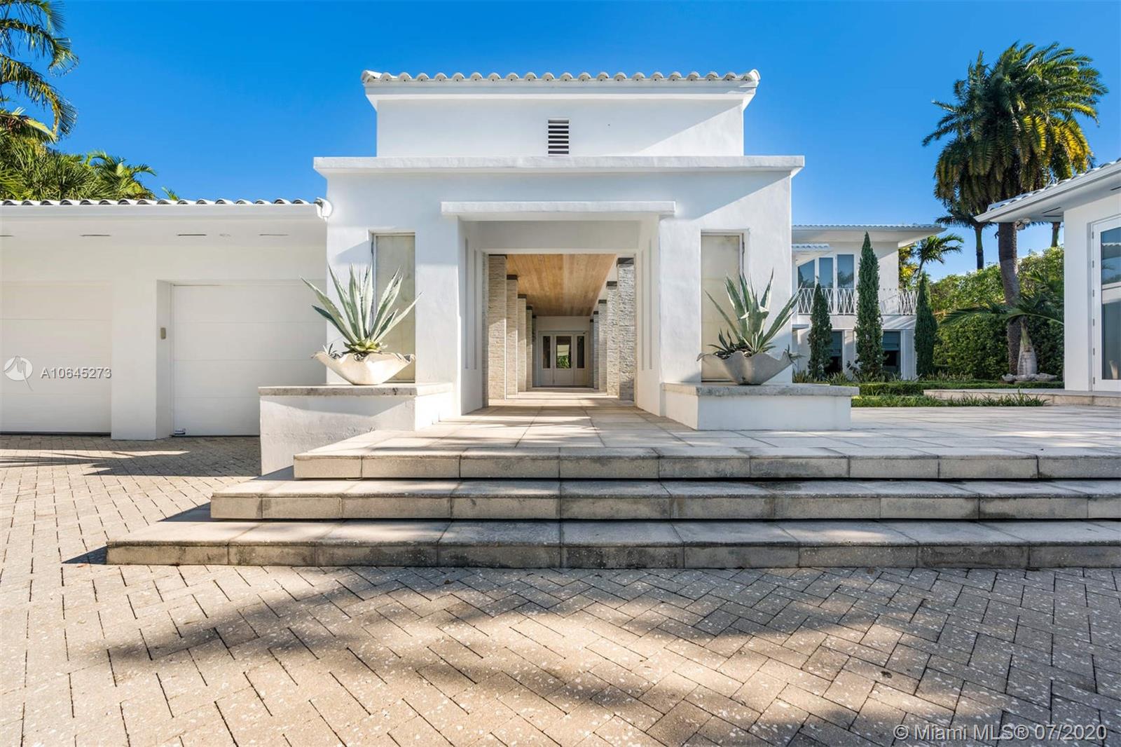 1475 North View Drive Miami Beach, FL 33140 - Photo 4 of 27 a view of white house with a potted plant and a table and chairs