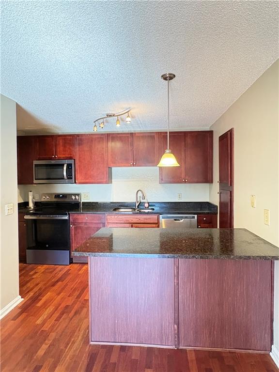 2657 Lenox Road Northeast, Unit 31 Atlanta, GA 30324 - Photo 5 of 18 a kitchen with kitchen island granite countertop a stove and a sink