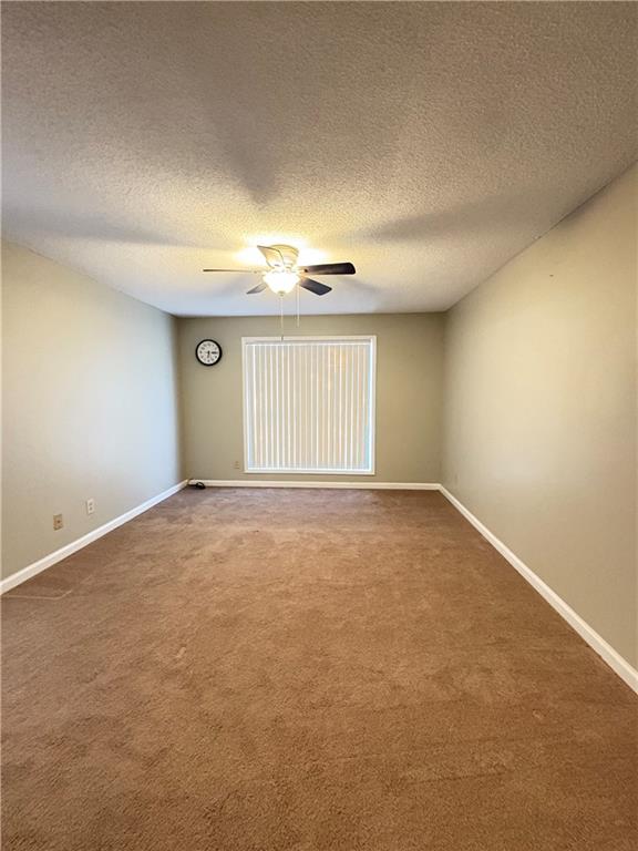 2657 Lenox Road Northeast, Unit 31 Atlanta, GA 30324 - Photo 7 of 18 an empty room with windows and chandelier fan