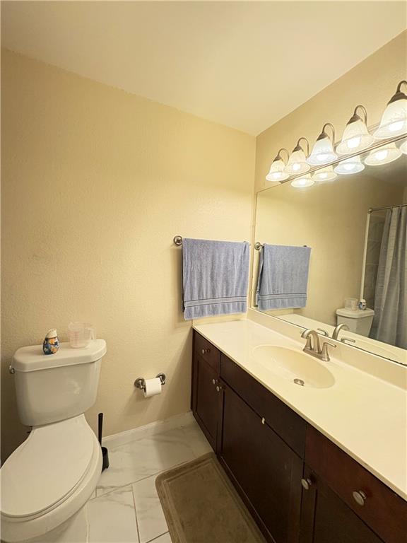 2657 Lenox Road Northeast, Unit 31 Atlanta, GA 30324 - Photo 8 of 18 a bathroom with a sink mirror vanity and toilet