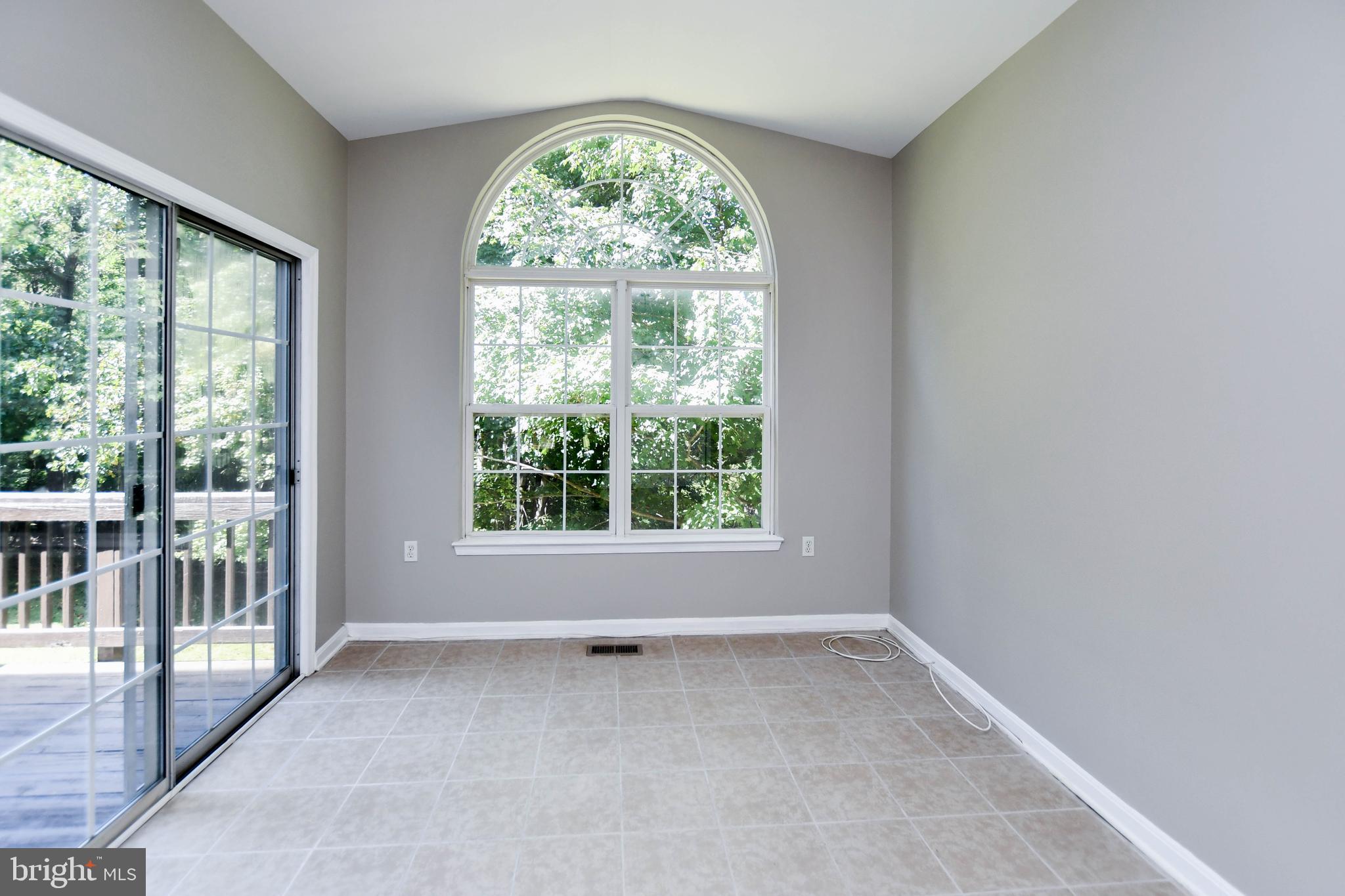 4308 Huntshire Road Randallstown, MD 21133 - Photo 17 of 40 an empty room with wooden floor and a window