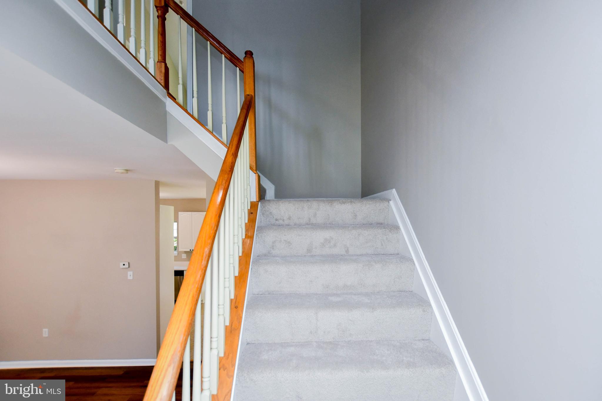 4308 Huntshire Road Randallstown, MD 21133 - Photo 19 of 40 a view of staircase with wooden floor and white walls