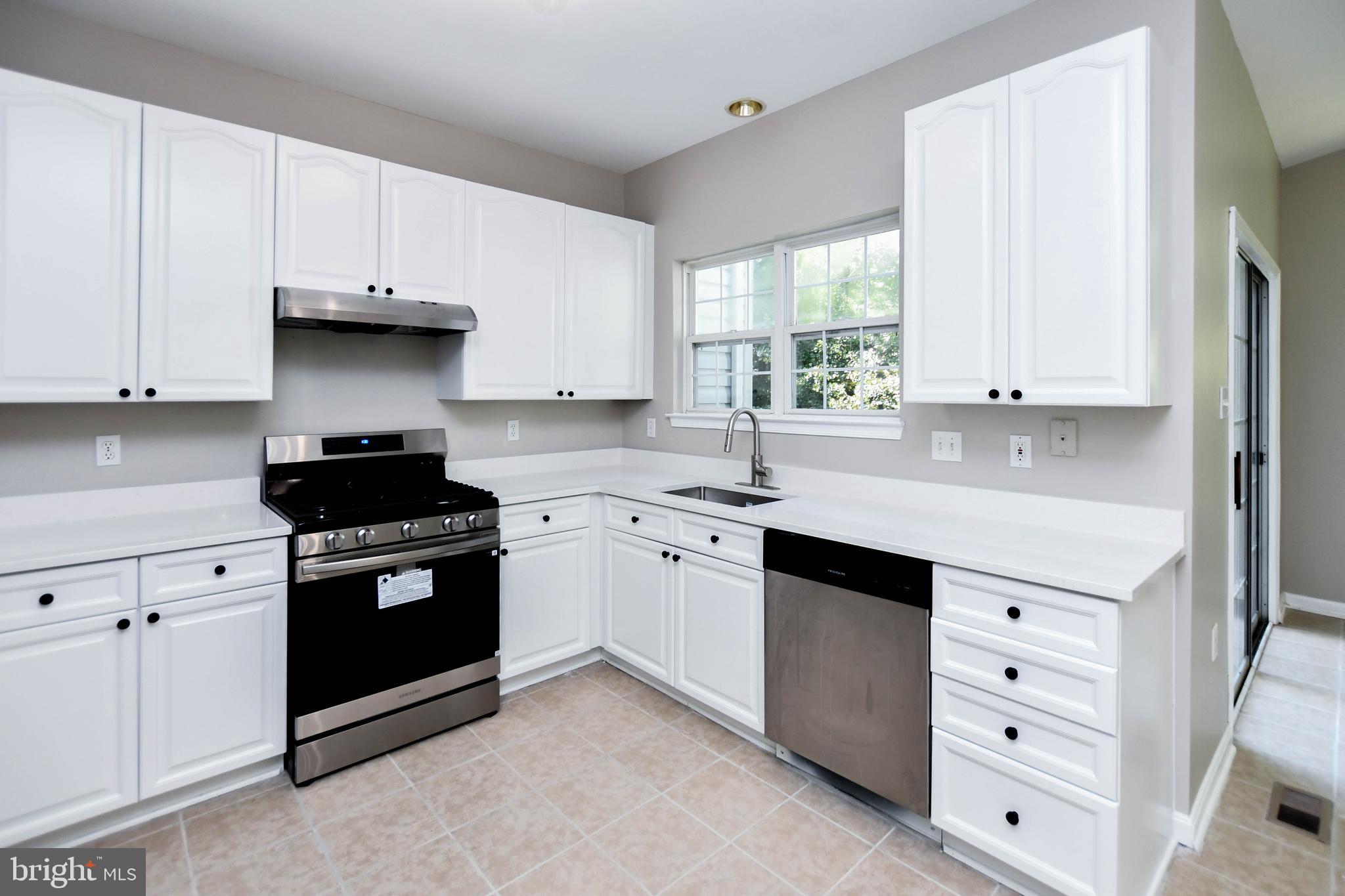 4308 Huntshire Road Randallstown, MD 21133 - Photo 2 of 40 a kitchen with cabinets appliances and a window