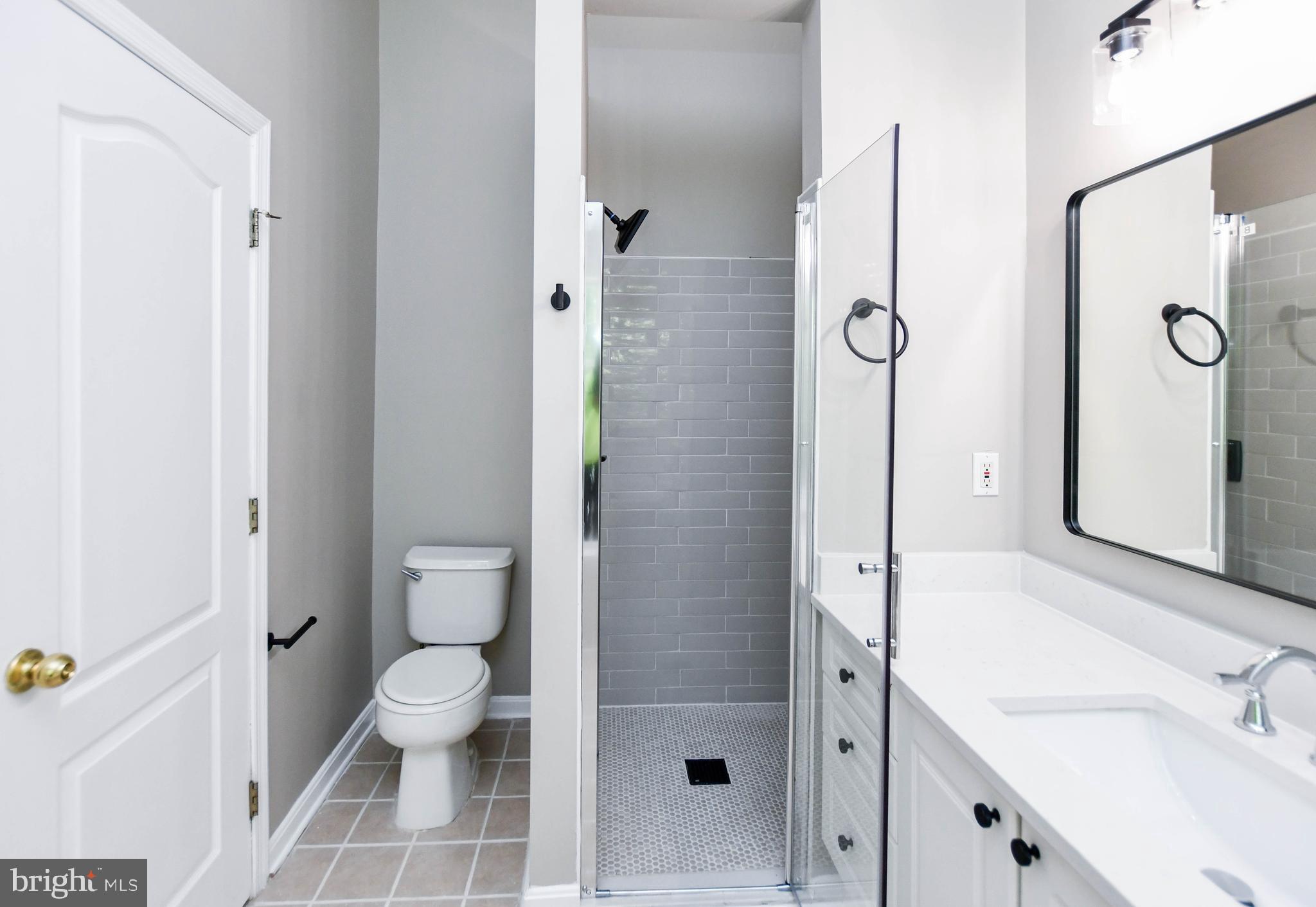 4308 Huntshire Road Randallstown, MD 21133 - Photo 28 of 40 a bathroom with a sink toilet and shower