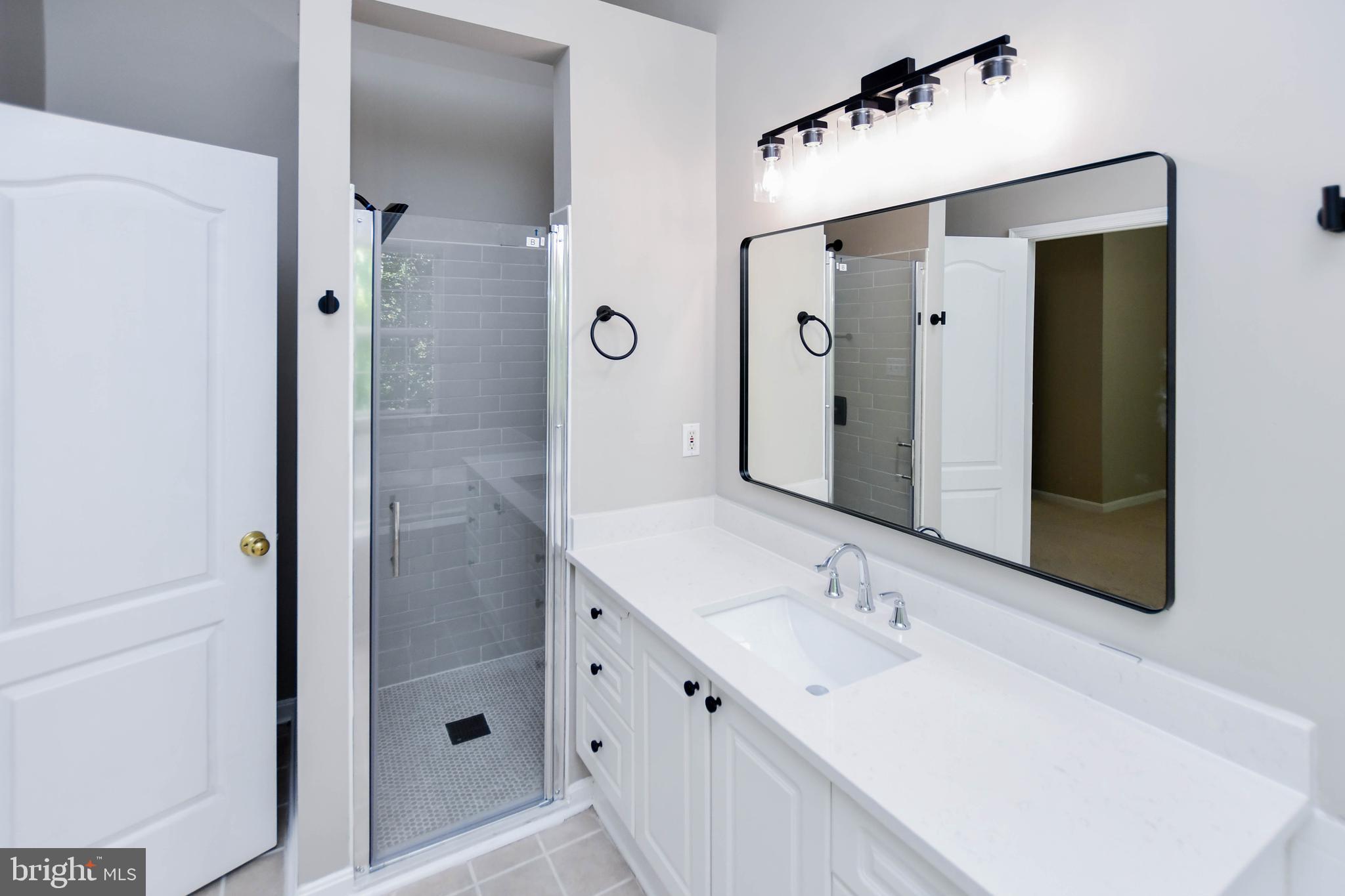 4308 Huntshire Road Randallstown, MD 21133 - Photo 29 of 40 a bathroom with a double vanity sink mirror and shower