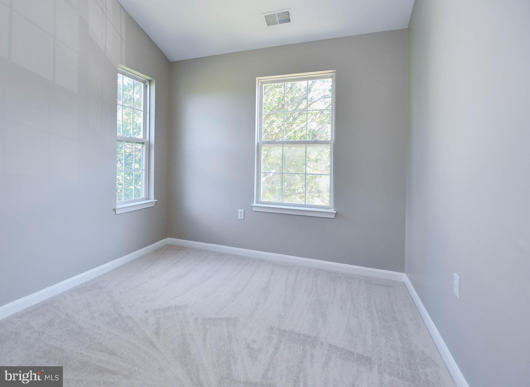 4308 Huntshire Road Randallstown, MD 21133 - Photo 31 of 40 an empty room with windows