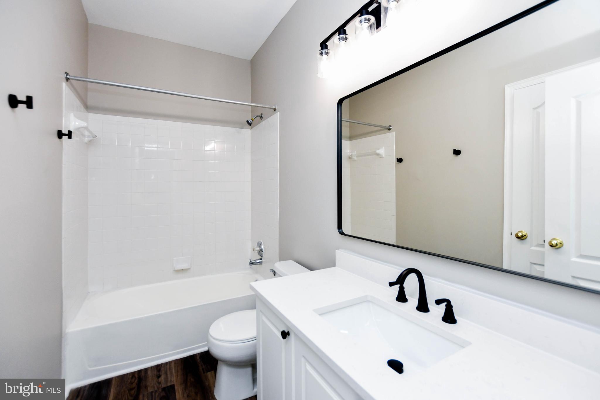 4308 Huntshire Road Randallstown, MD 21133 - Photo 33 of 40 a bathroom with a sink a toilet and shower