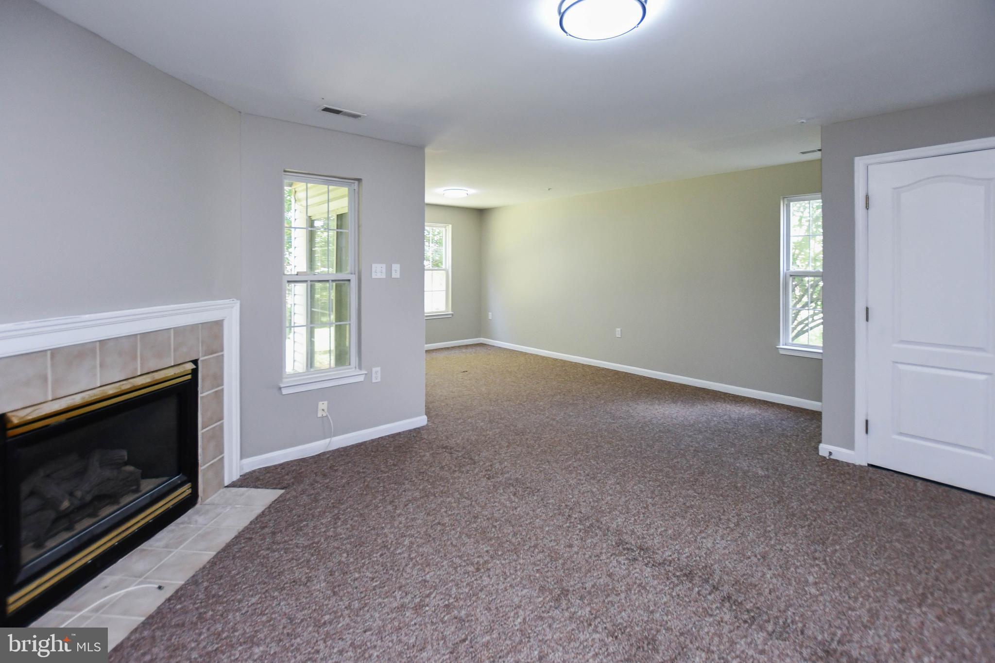 4308 Huntshire Road Randallstown, MD 21133 - Photo 37 of 40 a view of empty room with windows and fireplace