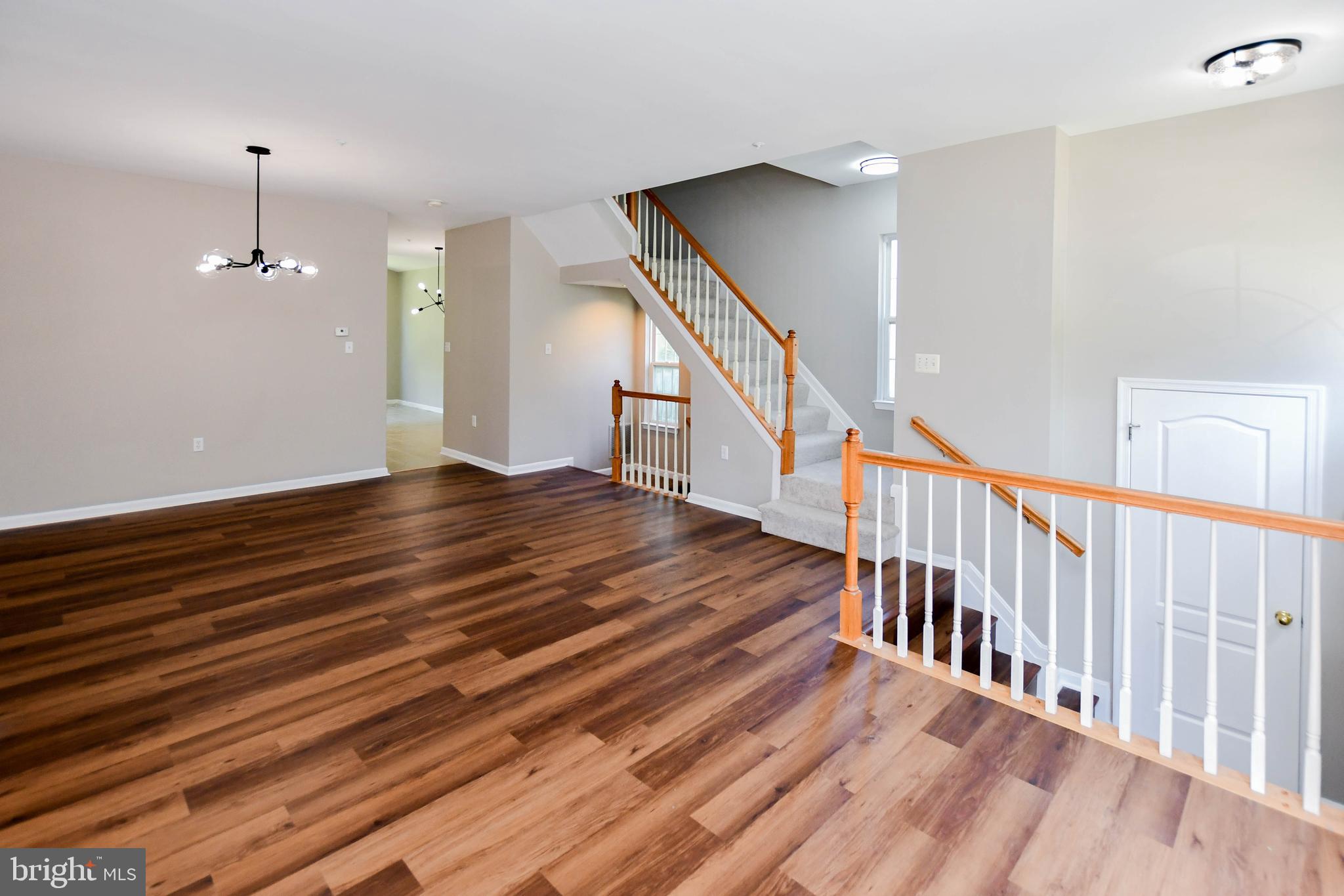4308 Huntshire Road Randallstown, MD 21133 - Photo 9 of 40 a view of a hallway with wooden floor and staircase