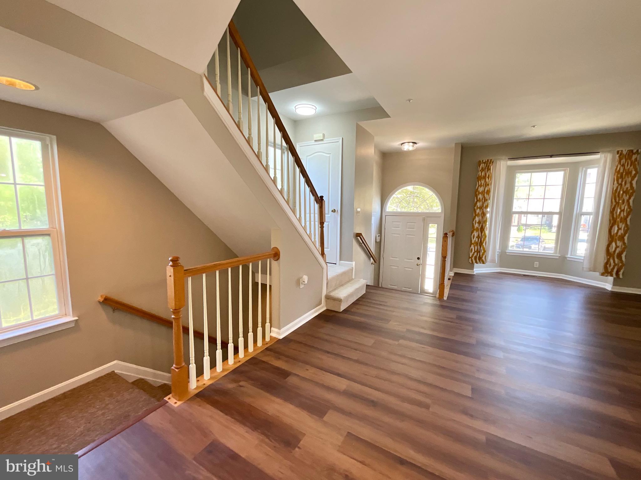 4308 Huntshire Road Randallstown, MD 21133 - Photo 10 of 40 wooden floor with windows and stairs in a room