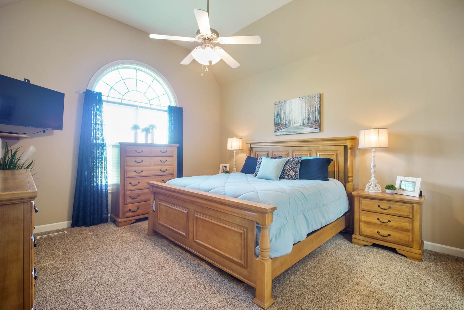 545 Sugar Flat Road Lebanon, TN 37087 - Photo 14 of 26 a bedroom with a bed and a chandelier
