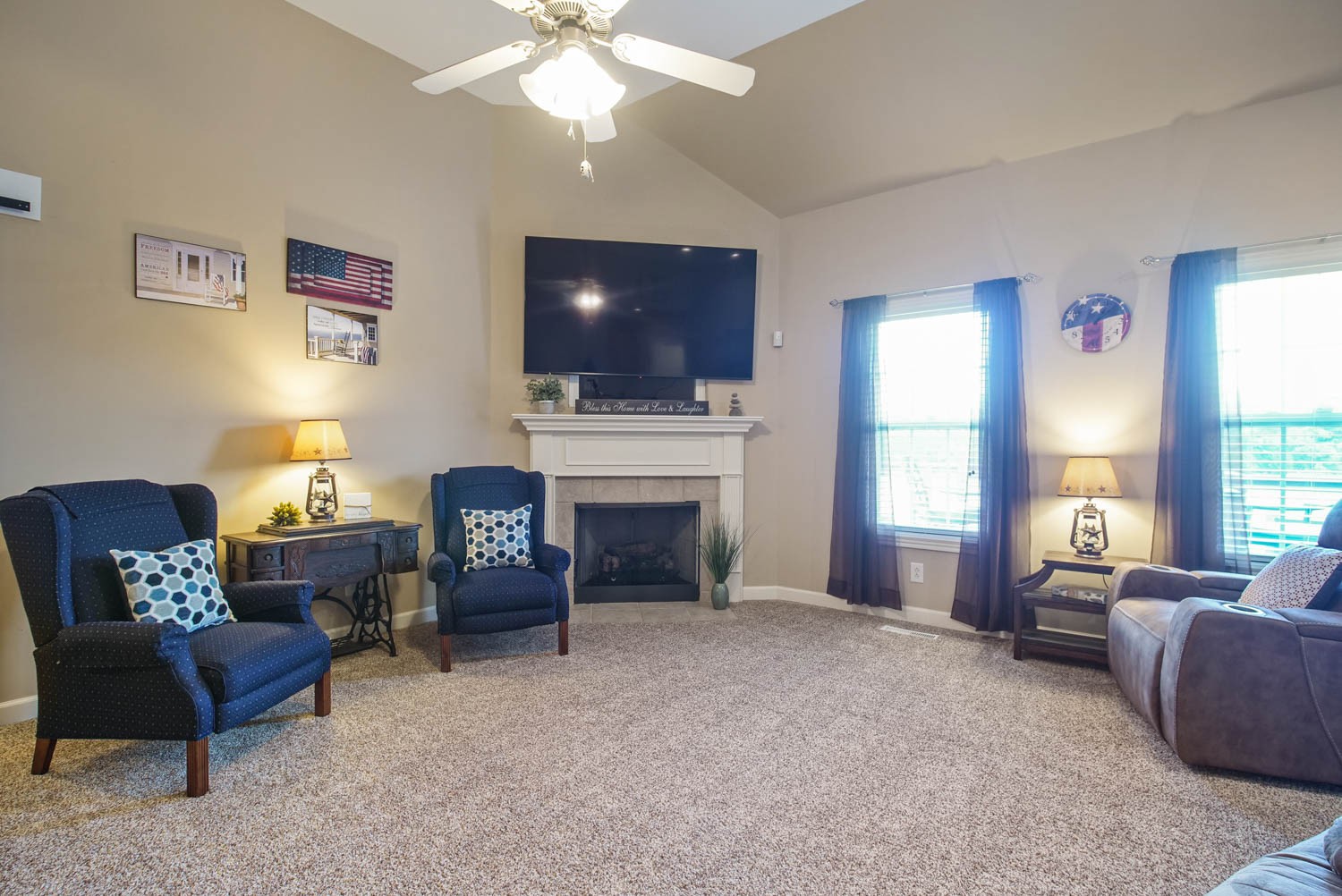 545 Sugar Flat Road Lebanon, TN 37087 - Photo 5 of 26 a living room with furniture a flat screen tv and a fireplace