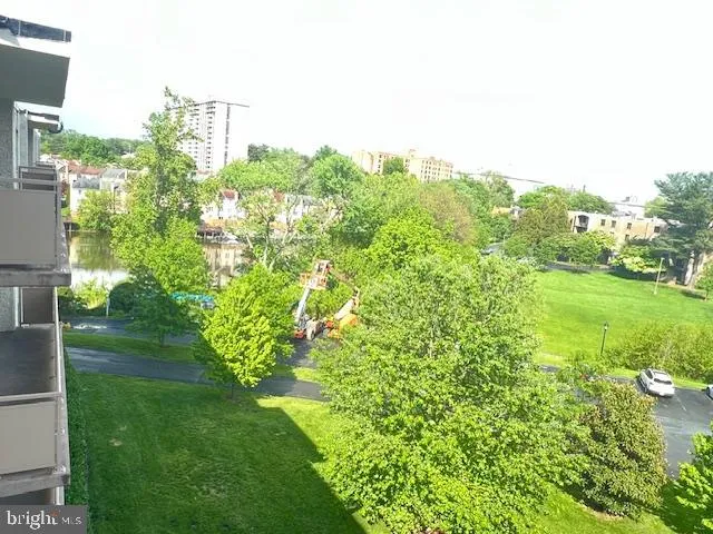 a view of a garden with a building in the background