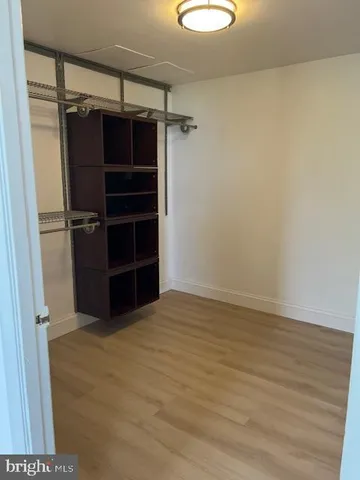 a view of walk in closet with clothes