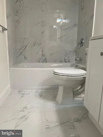 a bathroom with a sink toilet and bathtub