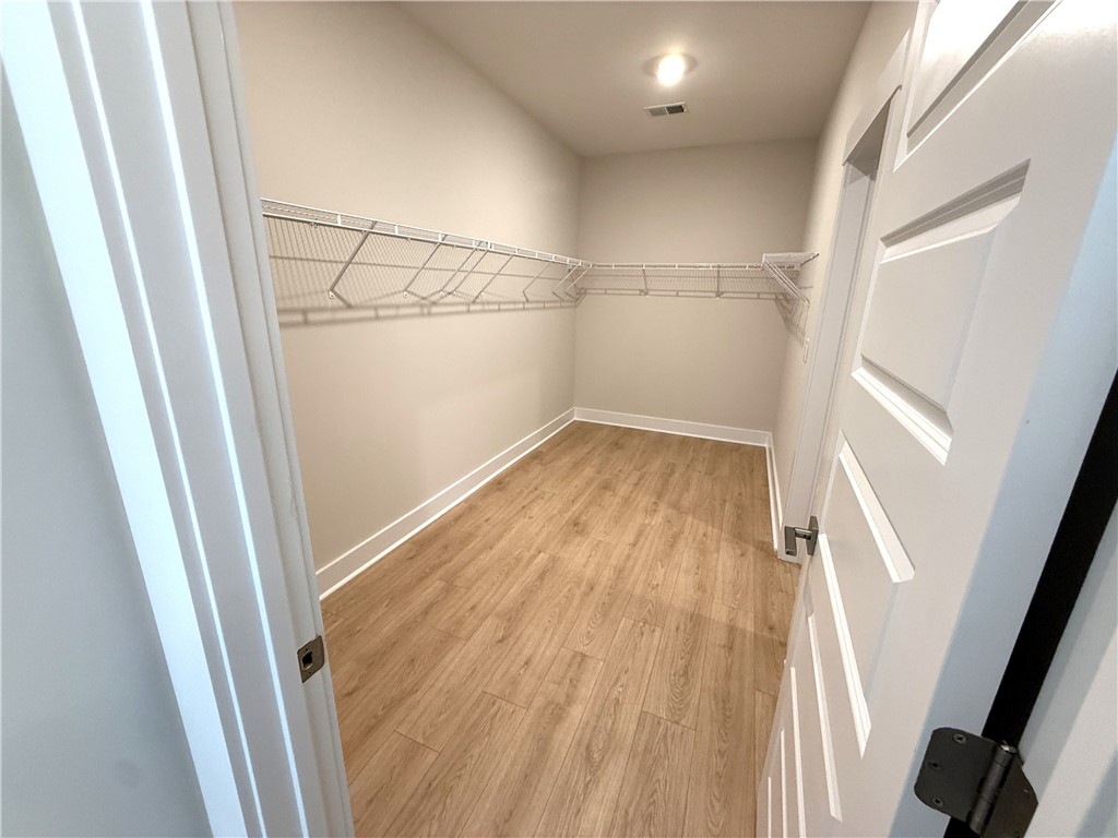 504 Tilman Court Anderson, SC 29621 - Photo 21 of 28 This spacious walk-in closet features convenient shelving and durable flooring for optimal organization.