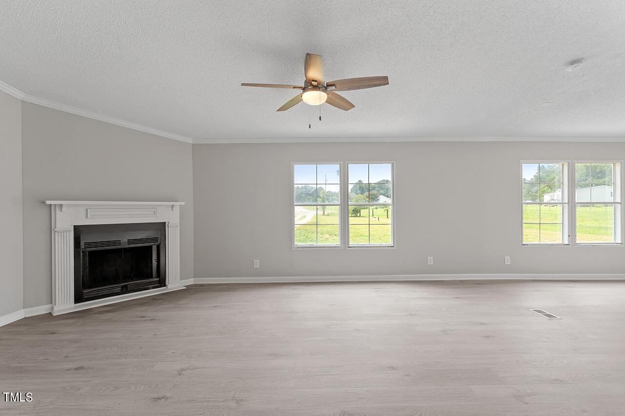 60 Beaver Run Road Spring Hope, NC 27882 - Photo 6 of 23 an empty room with windows and fireplace