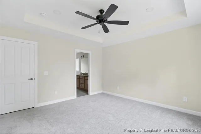 a view of an empty room and a ceiling fan