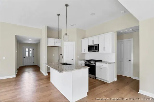 a kitchen with stainless steel appliances granite countertop a stove and a refrigerator
