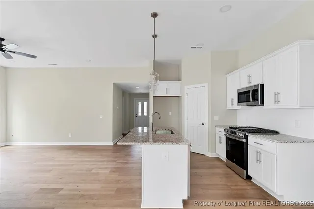 a view of a kitchen with stainless steel appliances
