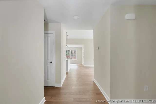 a view of a hallway with wooden floor
