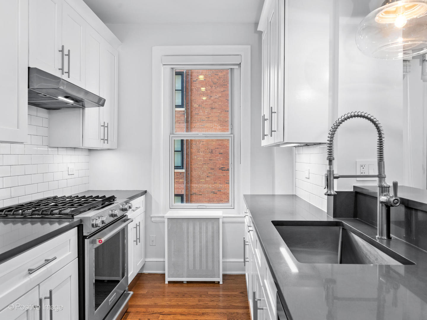 3240 North Lake Shore Drive, Unit 11B Chicago, IL 60657 - Photo 11 of 25 a kitchen with granite countertop a sink stainless steel appliances and cabinets