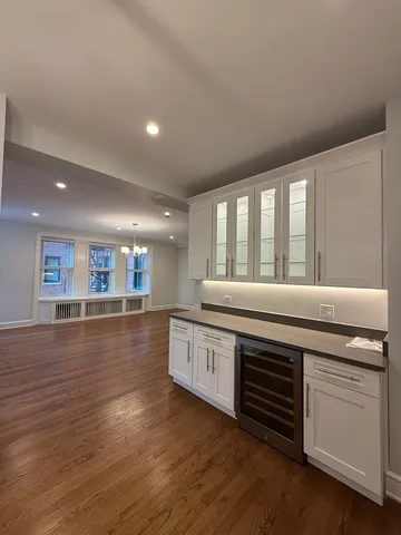 a kitchen with stainless steel appliances granite countertop a stove and a large window