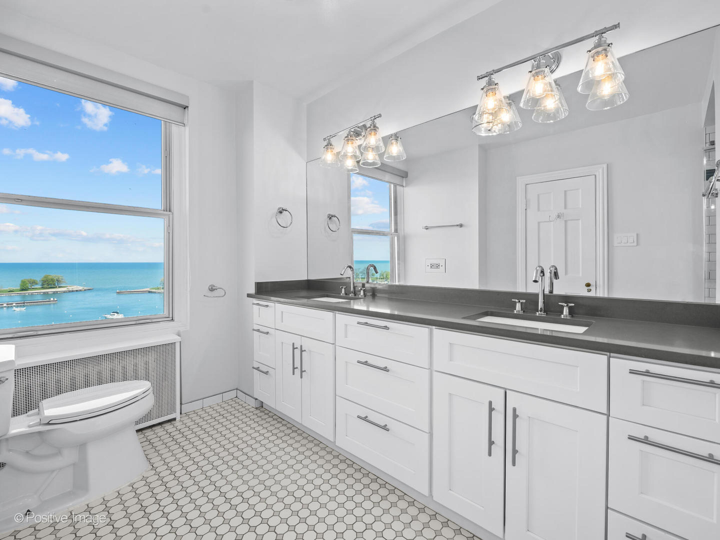 3240 North Lake Shore Drive, Unit 11B Chicago, IL 60657 - Photo 15 of 25 a bathroom with a granite countertop sink a toilet and a large mirror