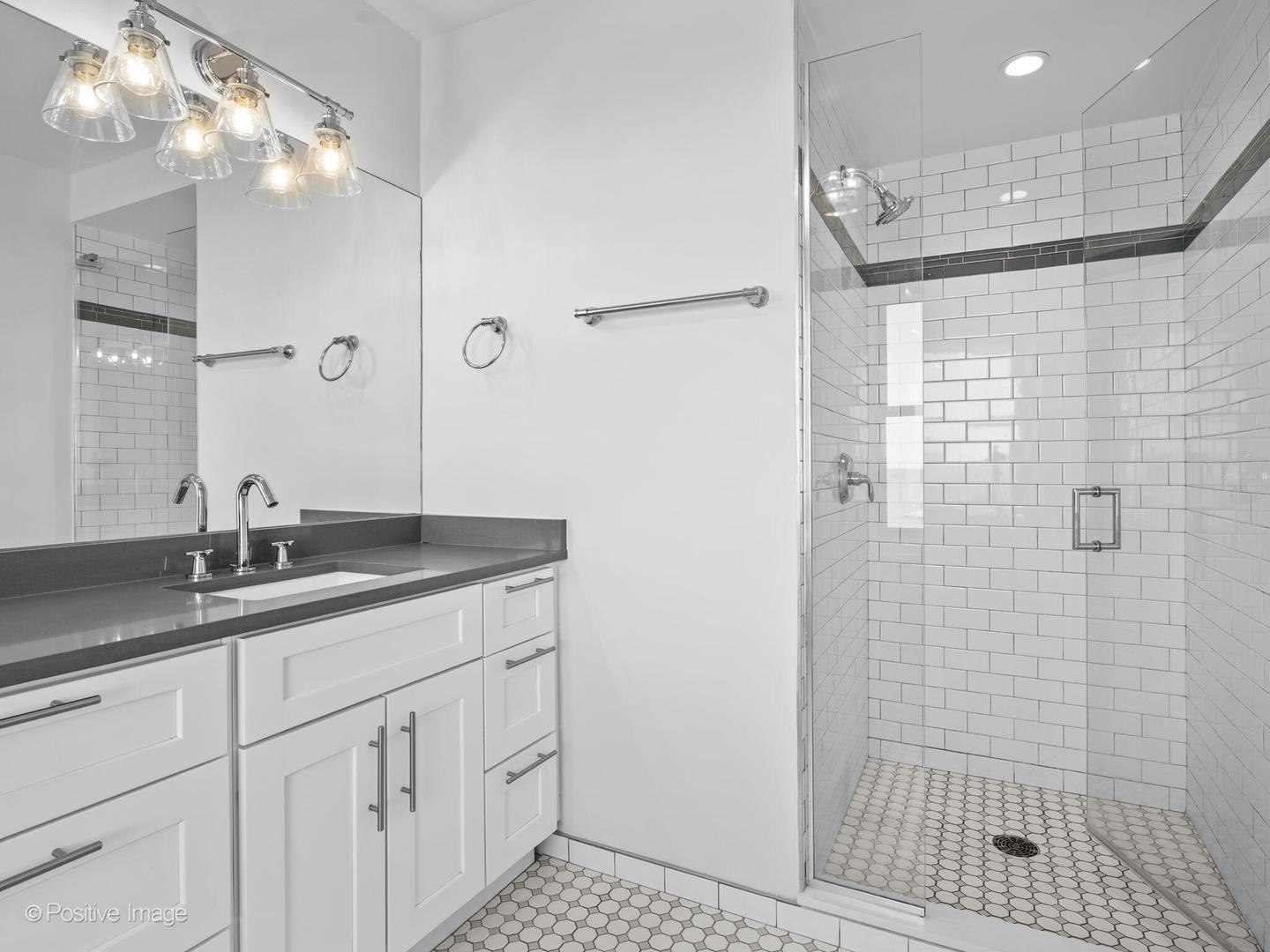 3240 North Lake Shore Drive, Unit 11B Chicago, IL 60657 - Photo 16 of 25 a bathroom with a granite countertop sink a shower and a mirror