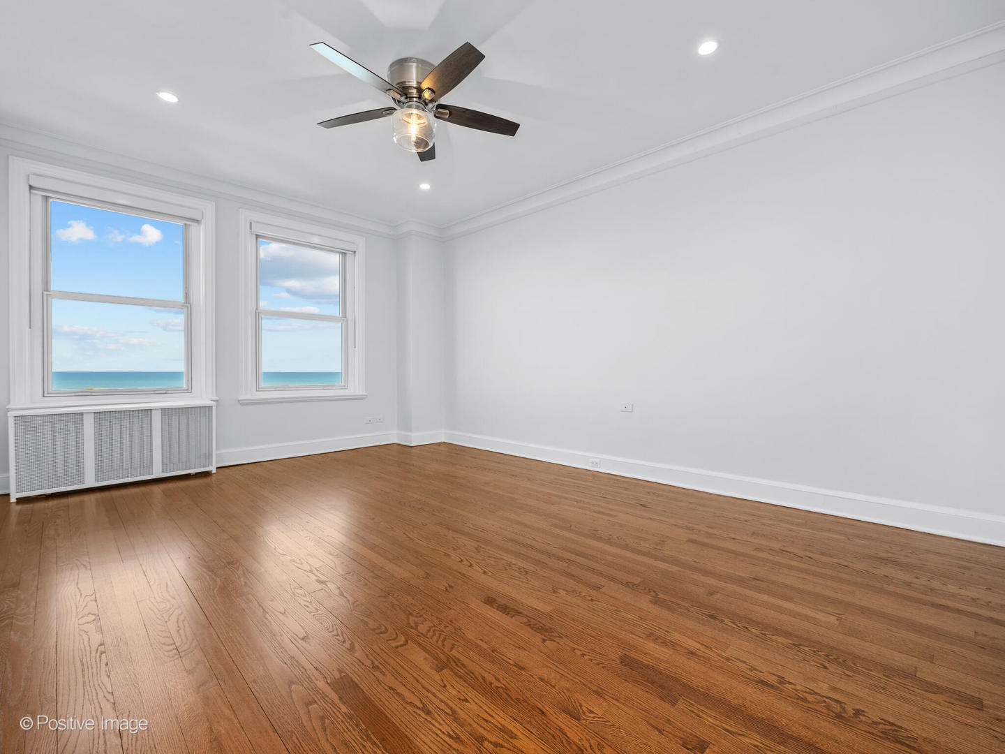 3240 North Lake Shore Drive, Unit 11B Chicago, IL 60657 - Photo 19 of 25 an empty room with wooden floor and windows