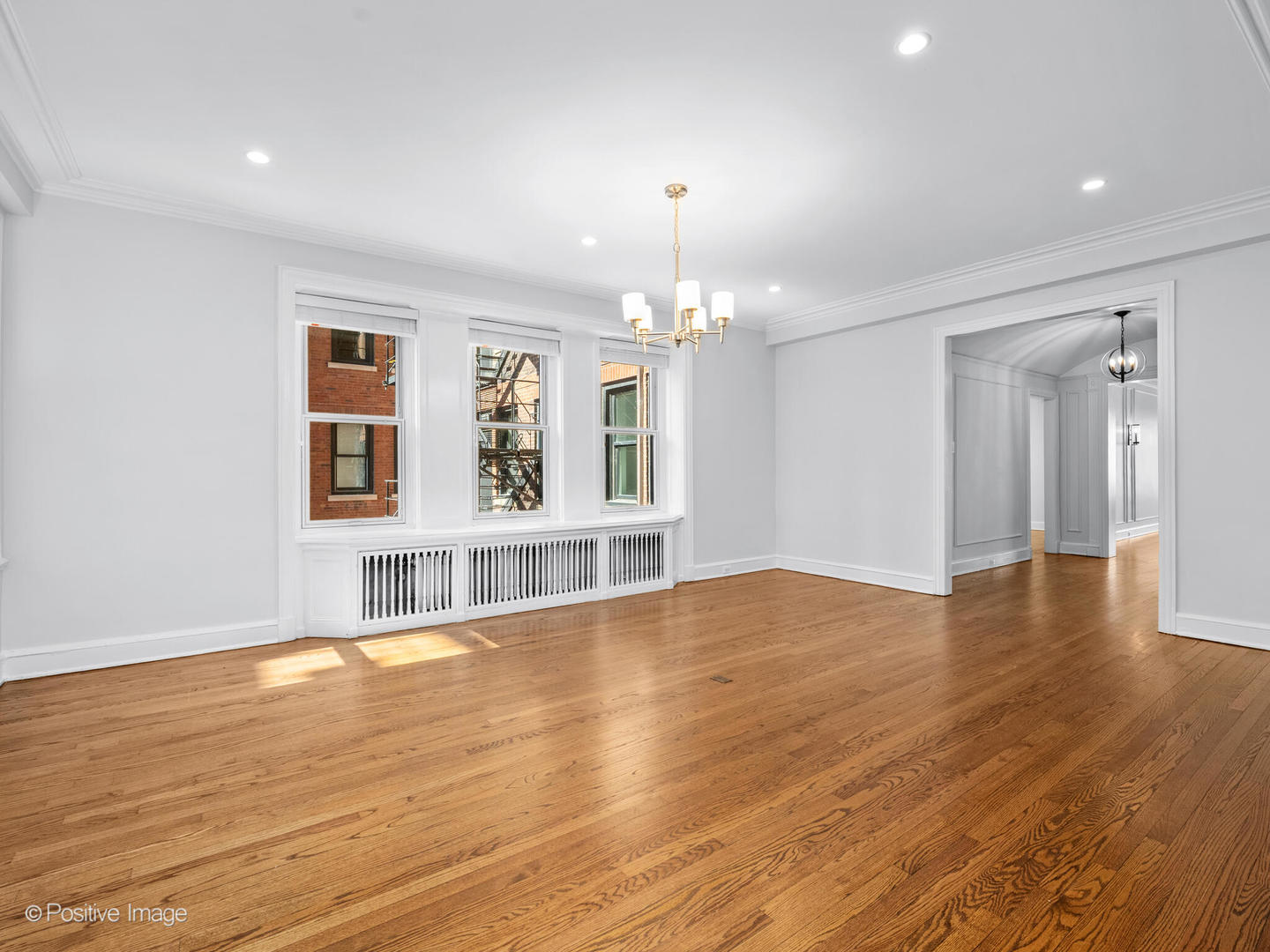 3240 North Lake Shore Drive, Unit 11B Chicago, IL 60657 - Photo 8 of 25 a view of an empty room with window and wooden floor