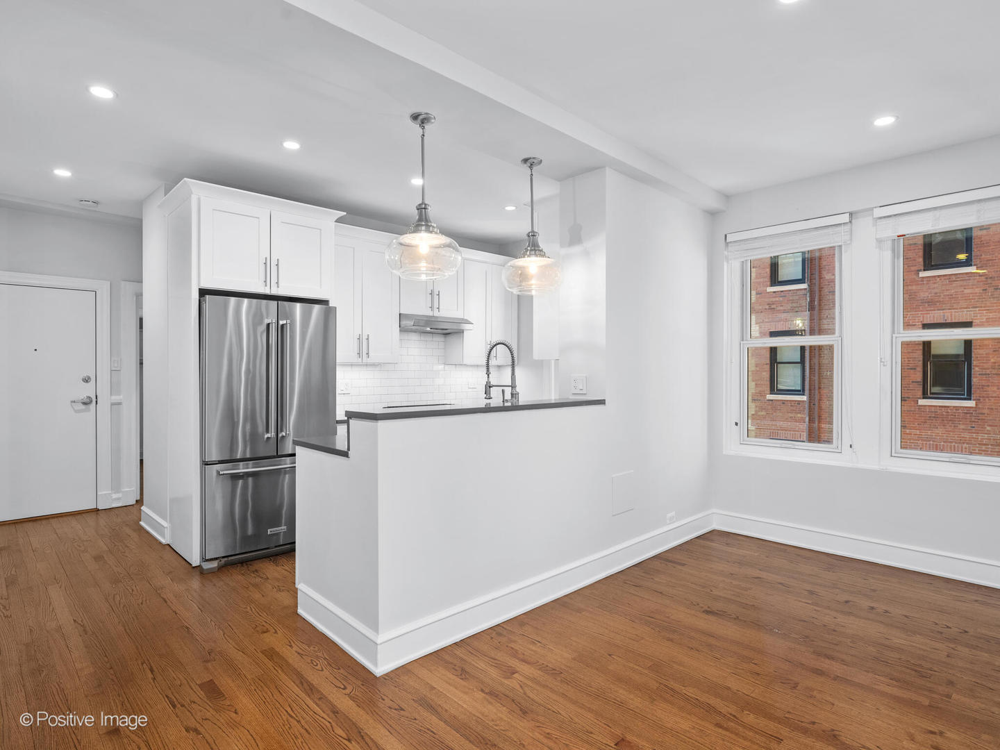3240 North Lake Shore Drive, Unit 11B Chicago, IL 60657 - Photo 10 of 25 a kitchen with kitchen island a counter top space wooden floor and stainless steel appliances
