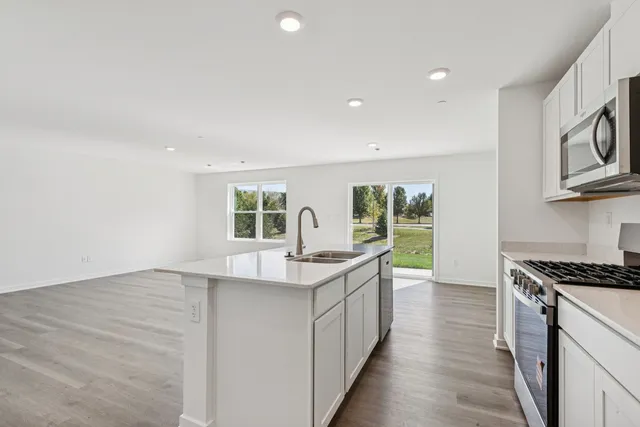a kitchen with counter top space and windows