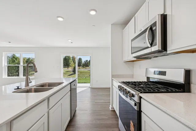 a kitchen that has a sink and a stove