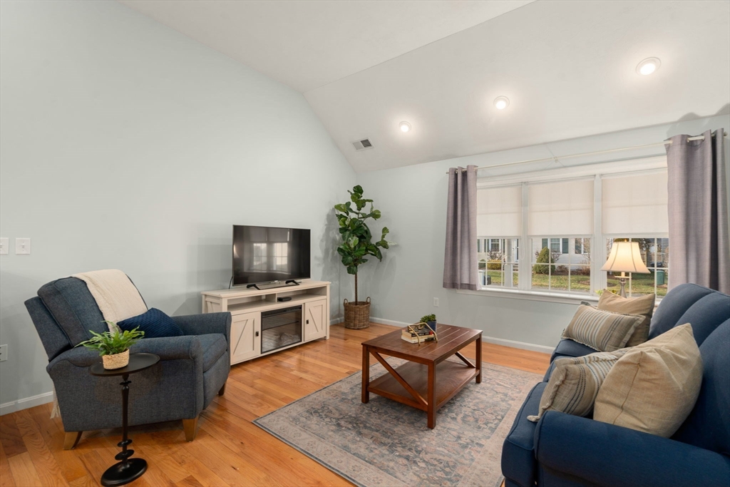 42 Brewster Road, Unit 42 Stoughton, MA 02072 - Photo 14 of 29 a living room with furniture a flat screen tv and a large window
