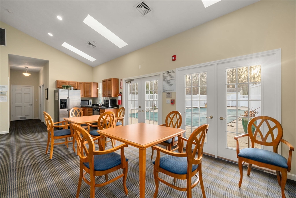 42 Brewster Road, Unit 42 Stoughton, MA 02072 - Photo 21 of 29 a dining room with furniture and wooden floor