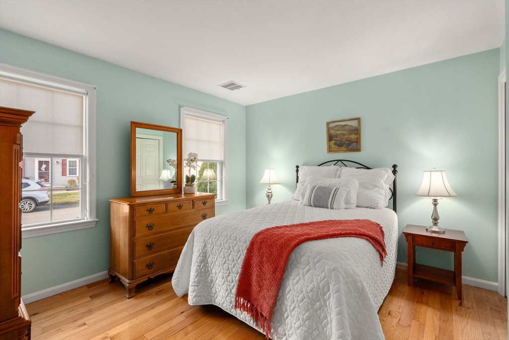 42 Brewster Road, Unit 42 Stoughton, MA 02072 - Photo 4 of 29 a bed room with a bed and a night stand