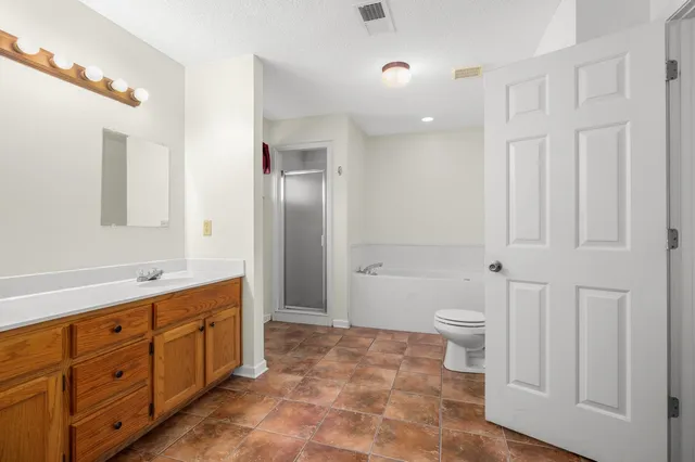 a spacious bathroom with a double vanity sink and a mirror